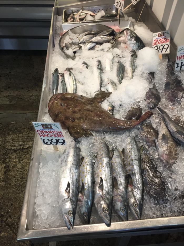 Fresh whole fish on ice at a Portland fish market, including Spanish mackerel and black sea bass